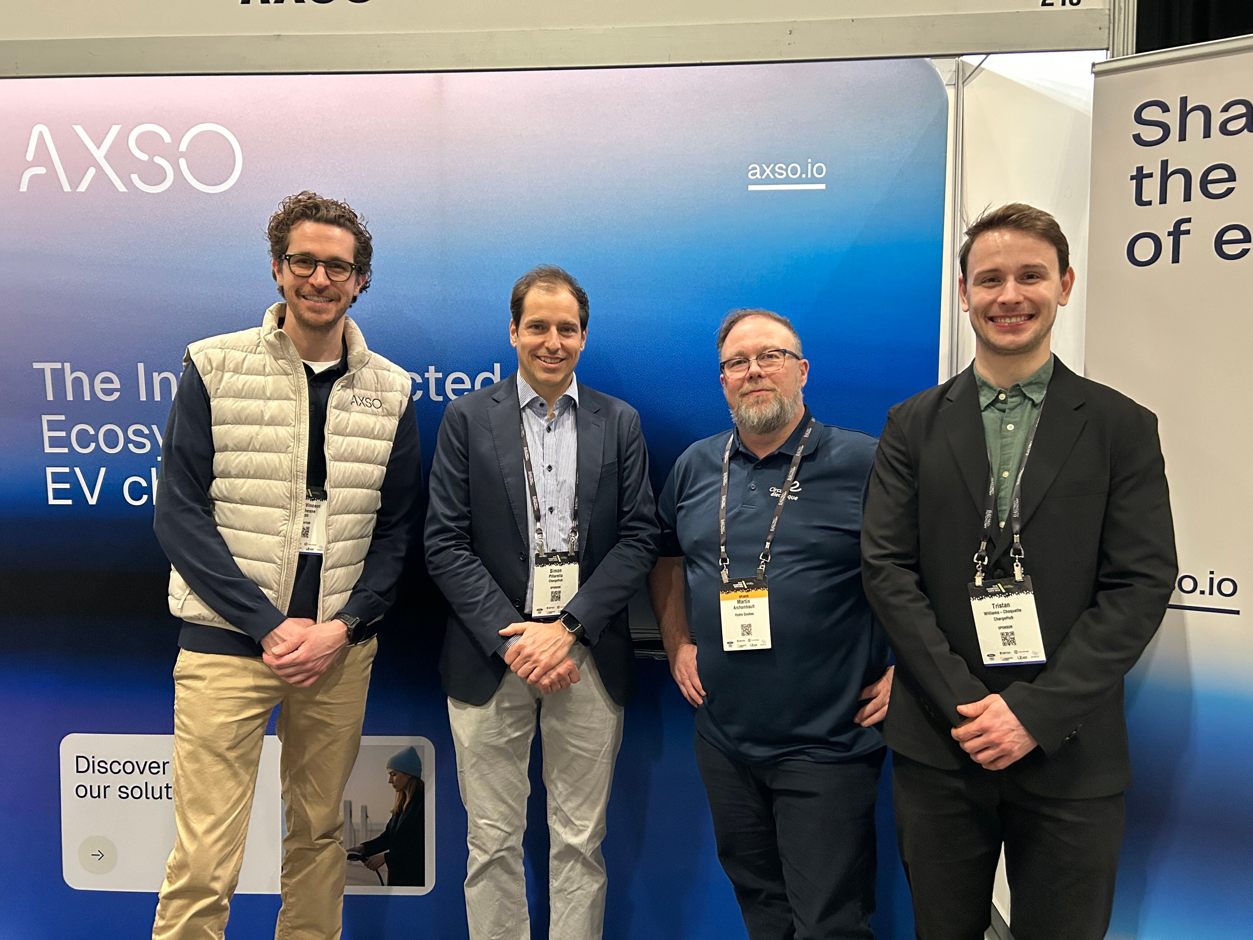 ChargeHub, AXSO, and Circuit électrique representatives at the AXSO booth during an EV charging industry event.
