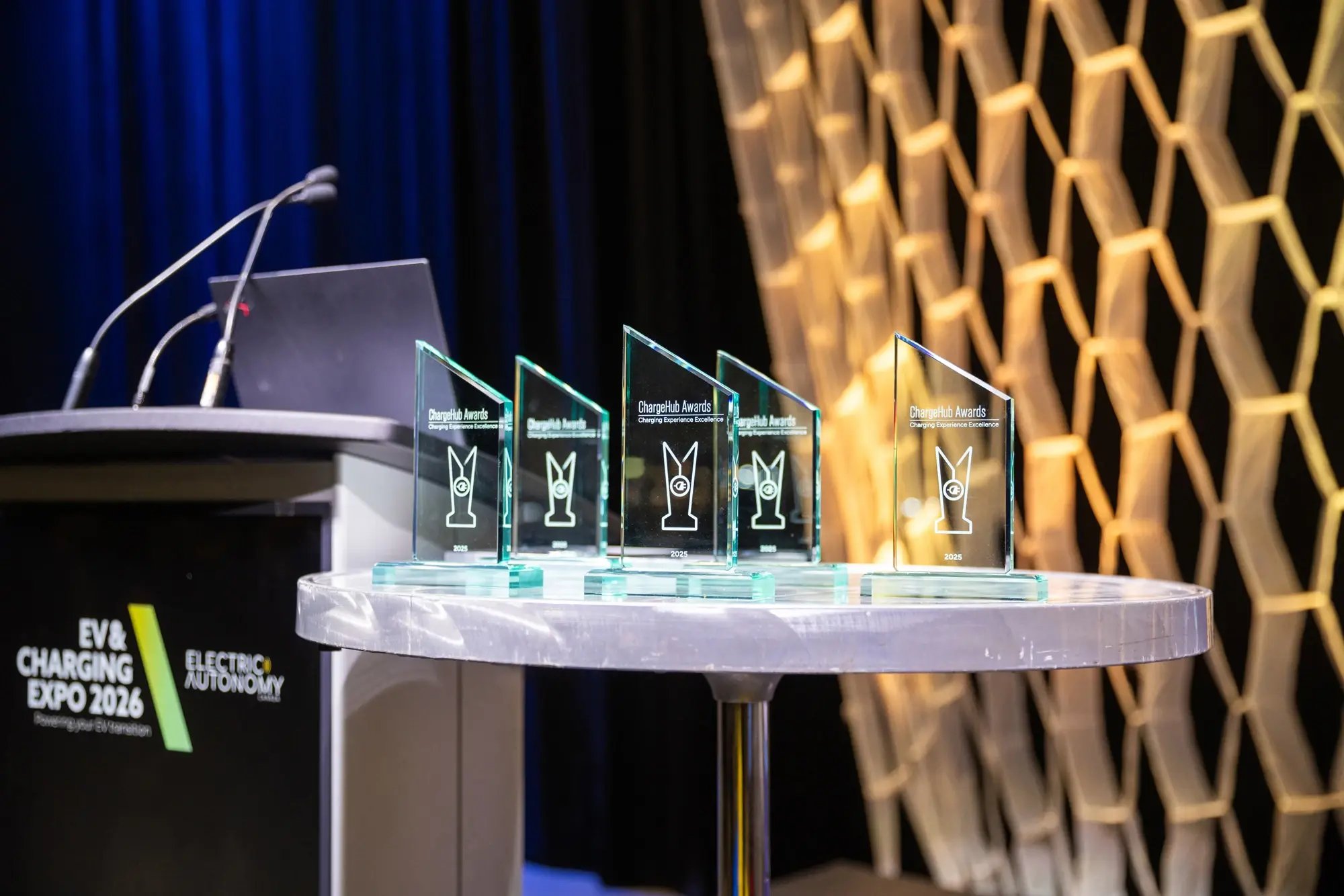 ChargeHub Awards trophies displayed beside the podium at EV and Charging Expo 2026.