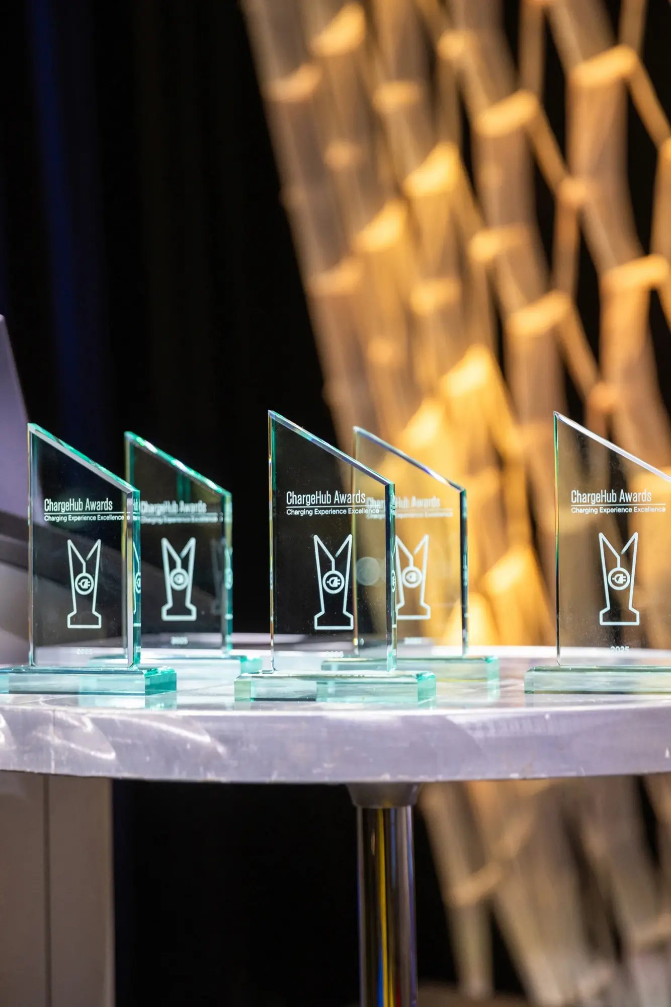 Close-up of ChargeHub Awards glass trophies on display at the ceremony.