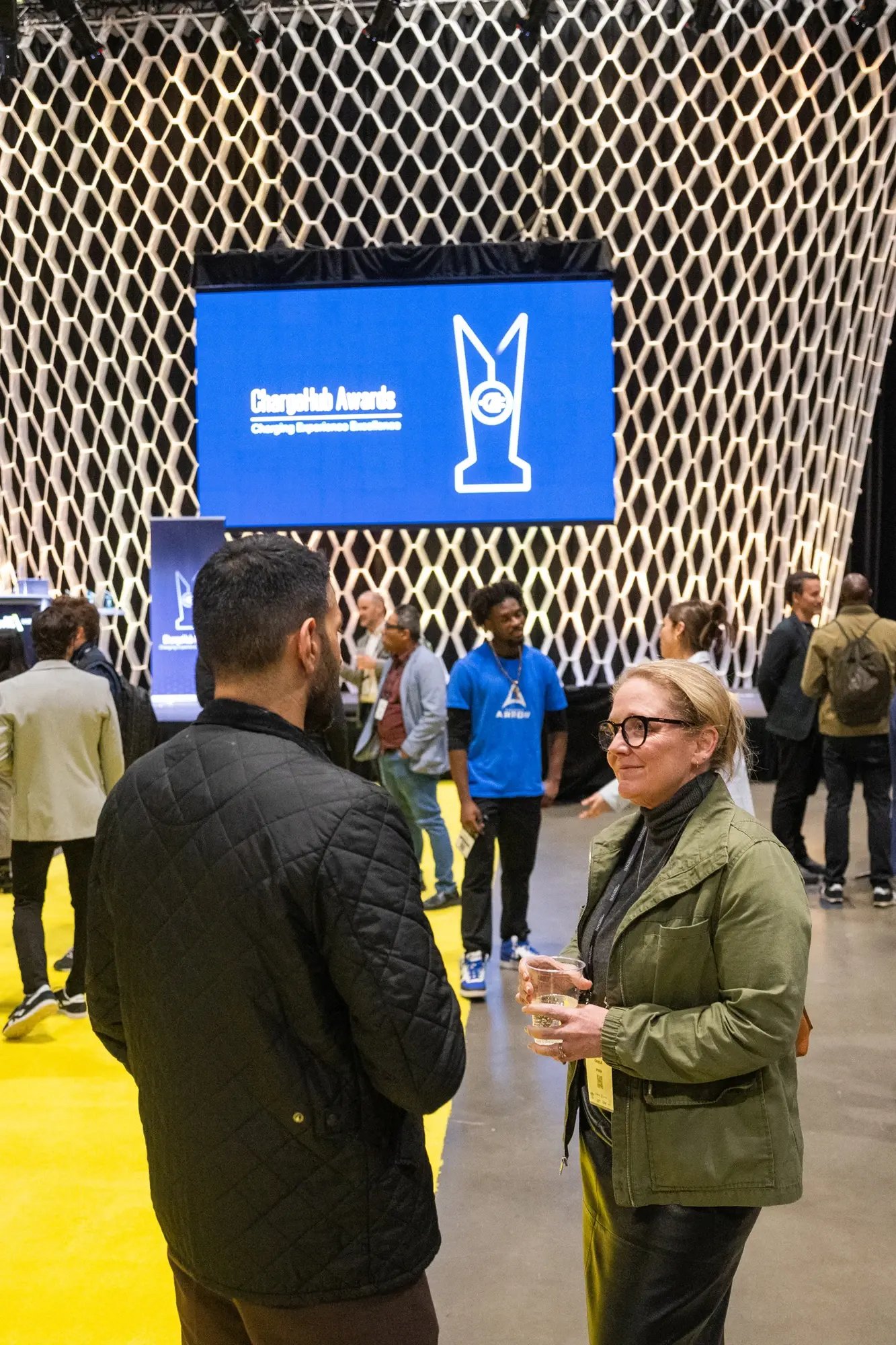 Attendees talking near the stage at the ChargeHub Awards ceremony.
