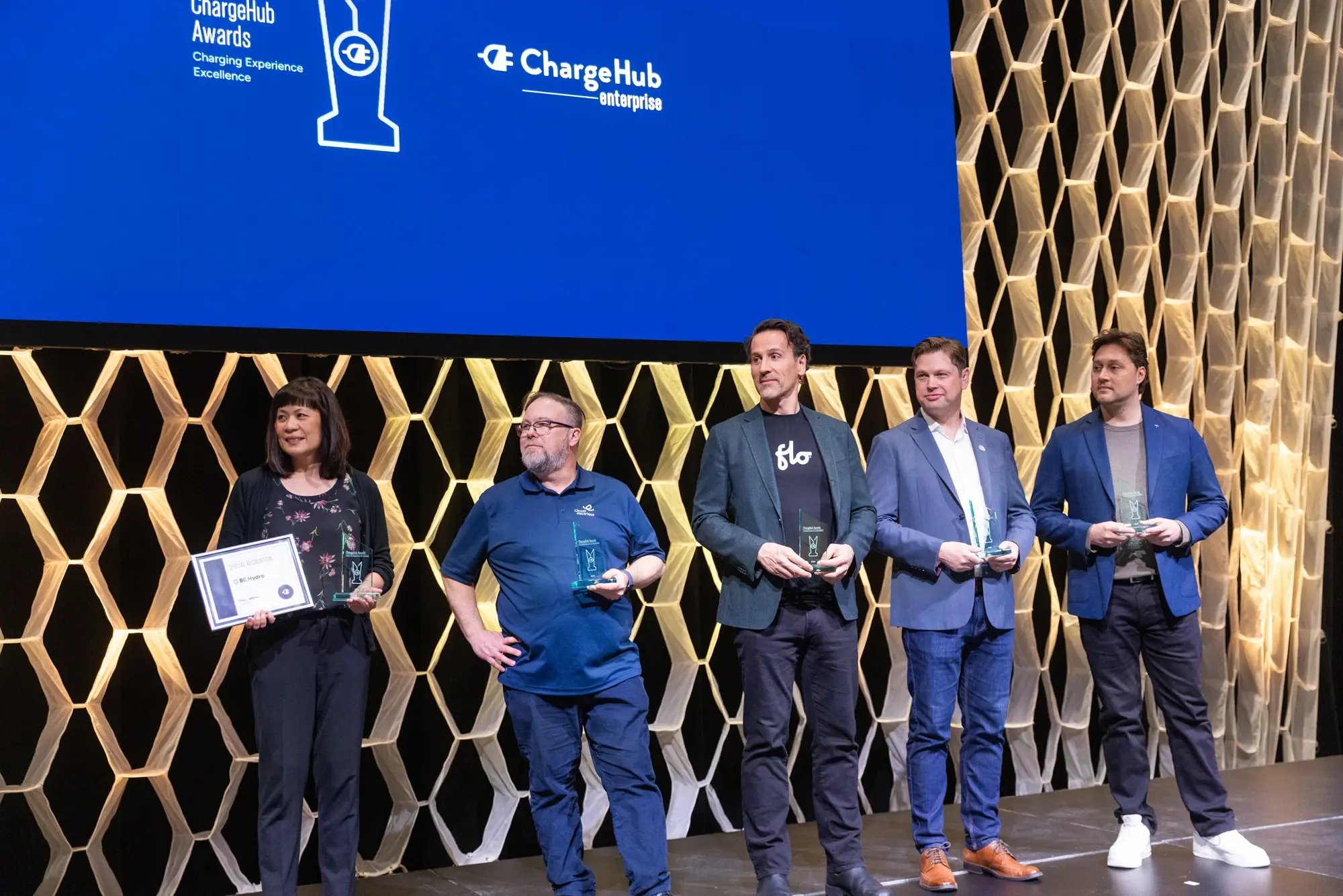 ChargeHub Awards recipients stand on stage holding trophies, including BC Hydro special recognition.