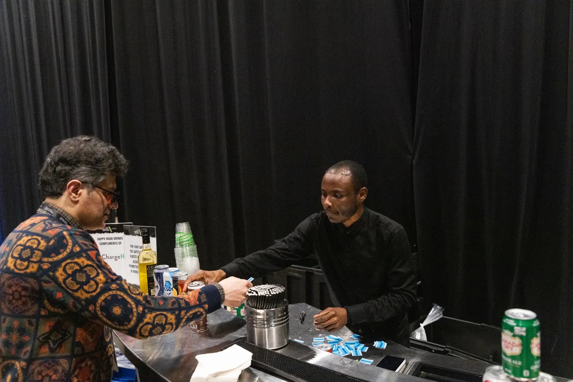 Bartender serving a drink at the ChargeHub-sponsored happy hour during the awards event.