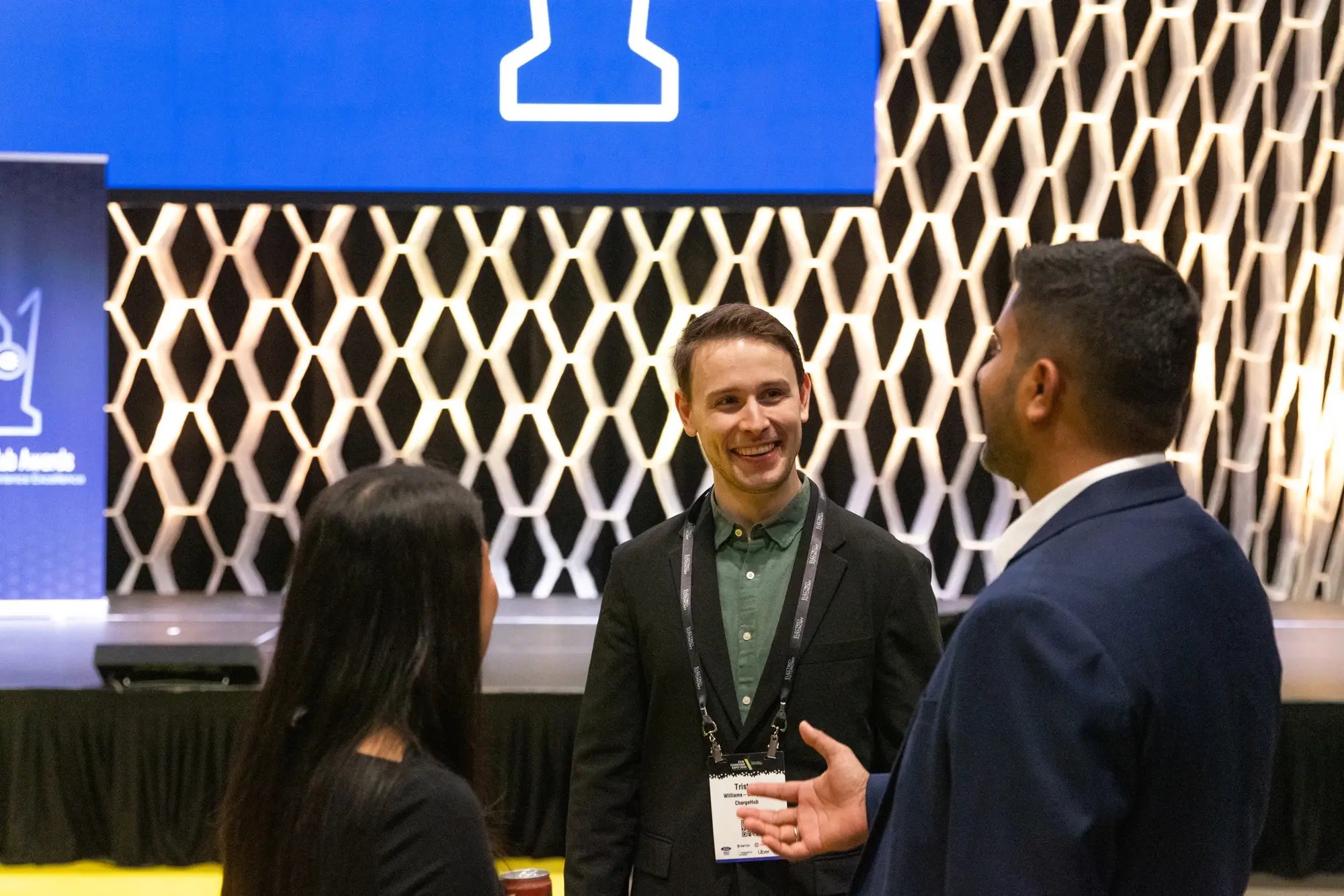 Attendees networking in front of the stage at the ChargeHub Awards ceremony.