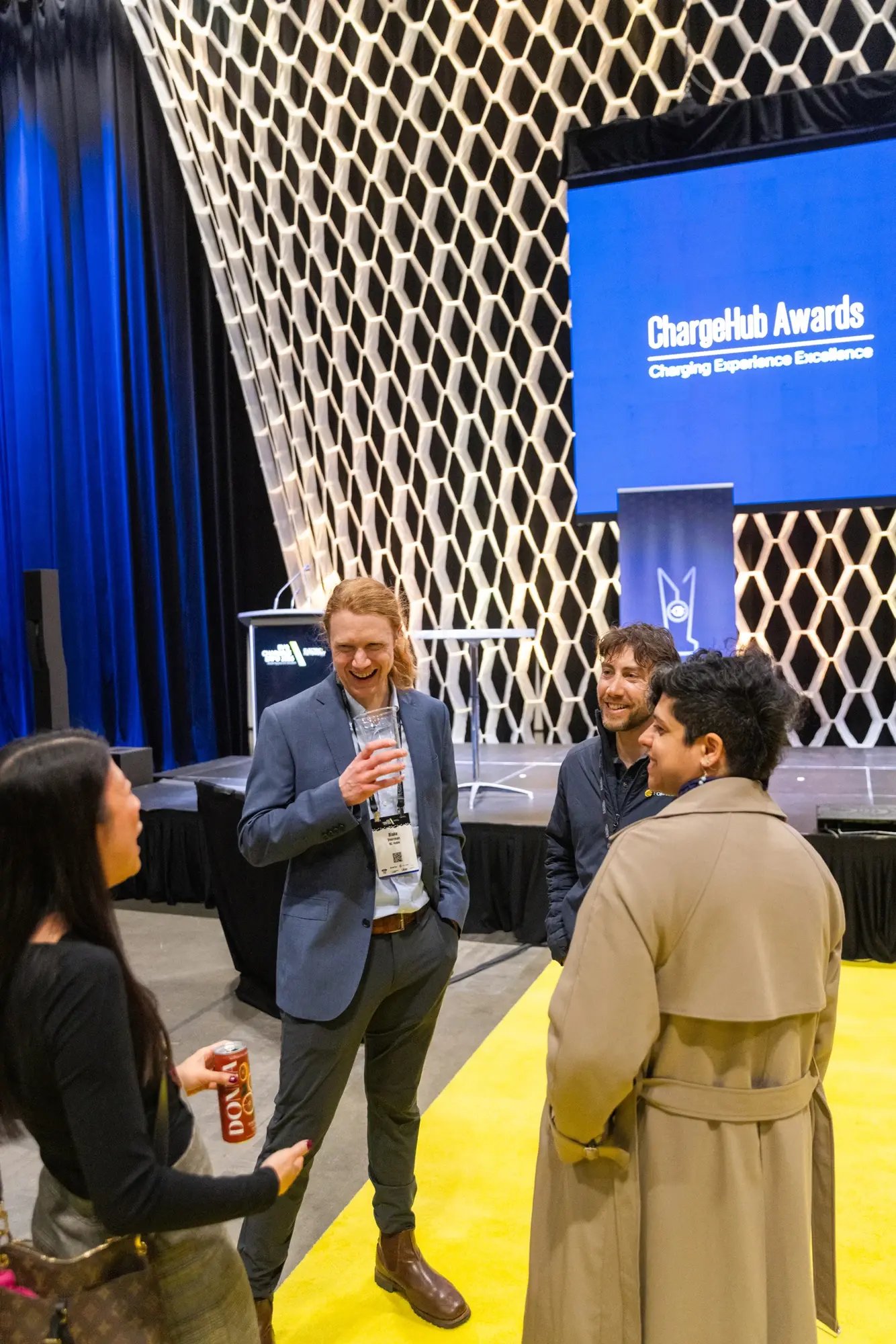 Guests talking near the stage during the ChargeHub Awards networking reception.