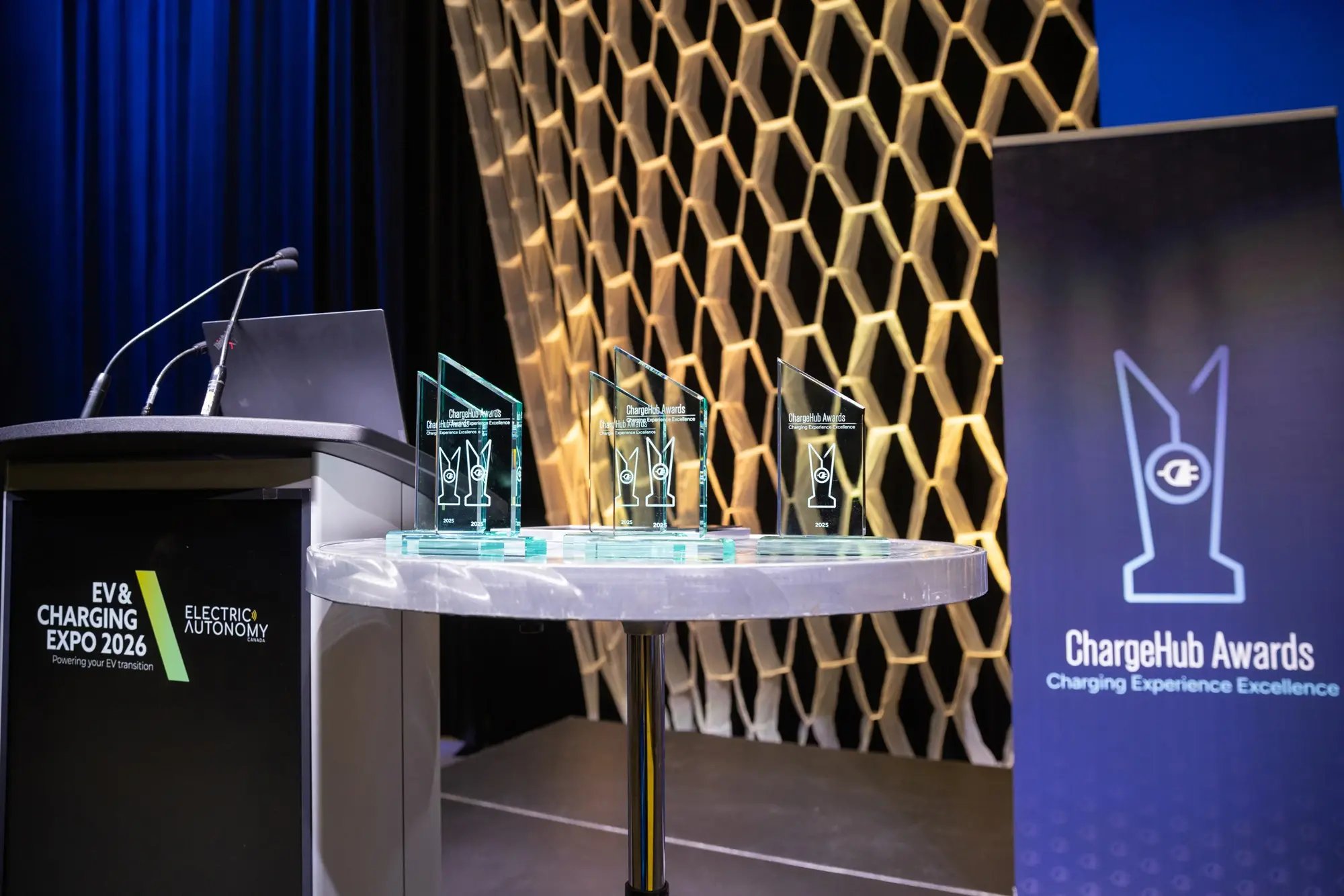 ChargeHub Awards trophies displayed beside the podium at EV and Charging Expo 2026.
