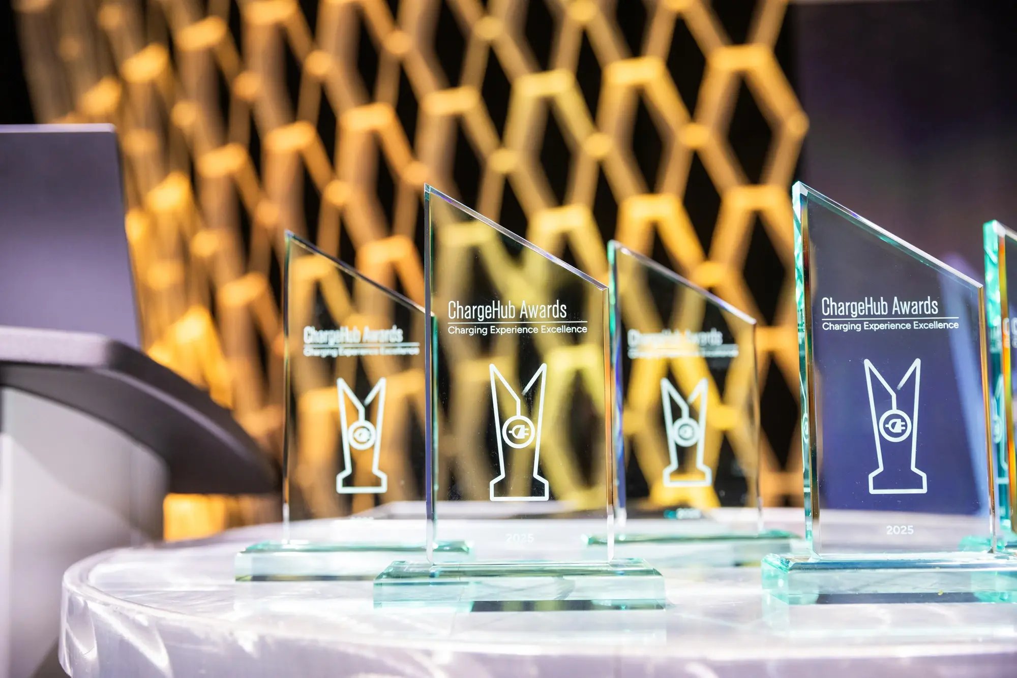 Close-up of ChargeHub Awards trophies displayed on a table before the ceremony.