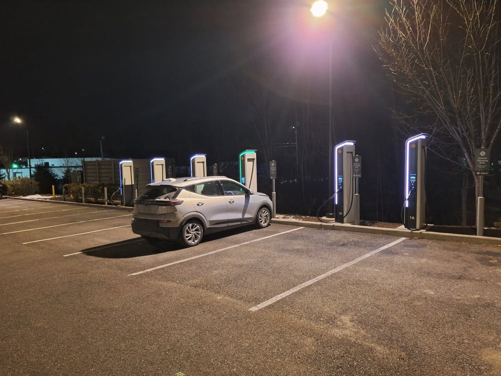 Electric vehicle charging overnight at public fast-charging stations