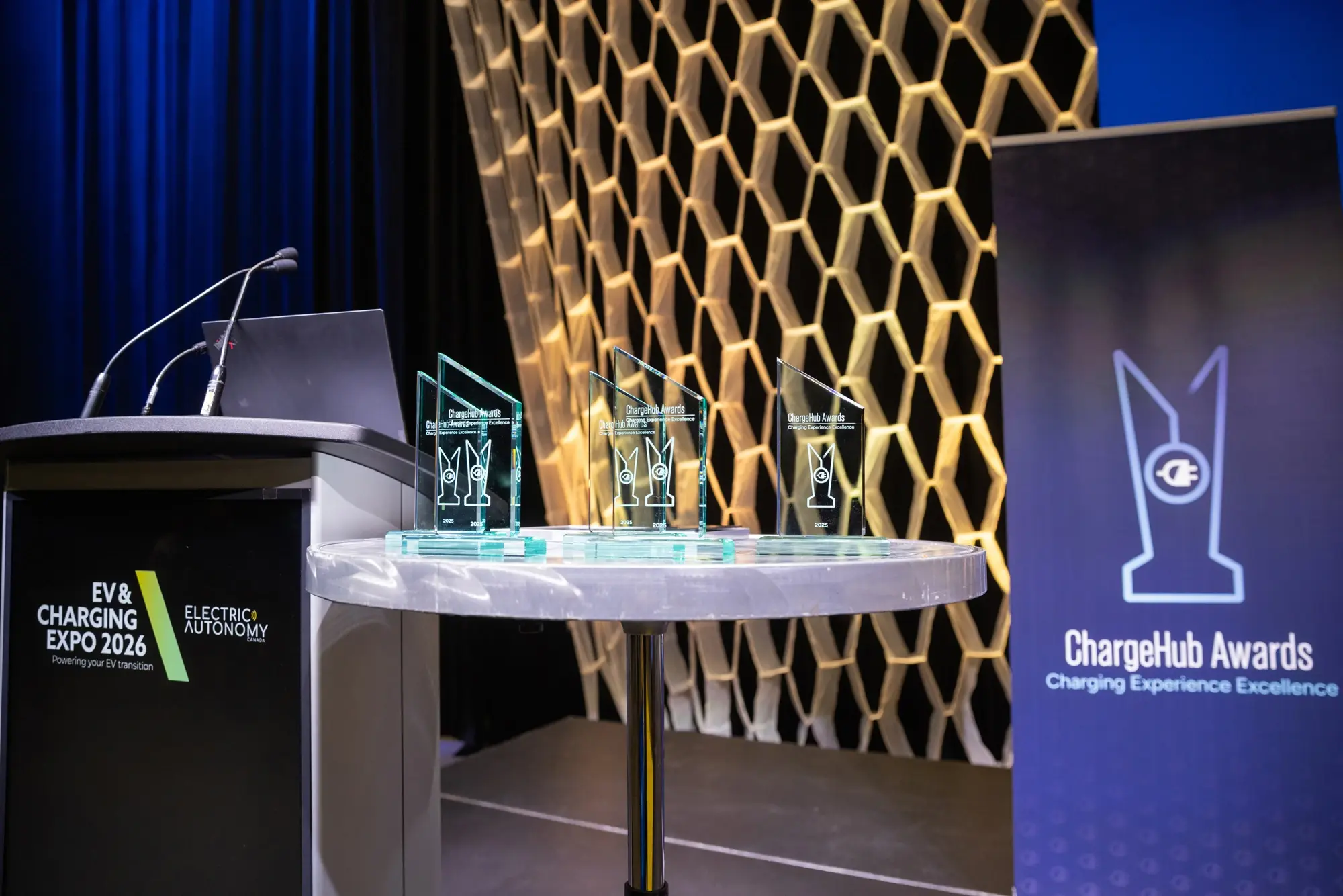ChargeHub Awards trophies displayed beside the podium at EV and Charging Expo 2026.