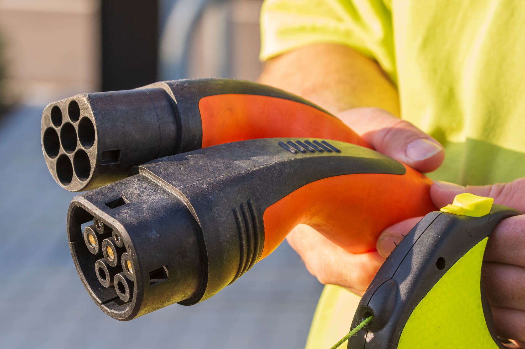 Electric vehicle charging station connector used to charge a car
